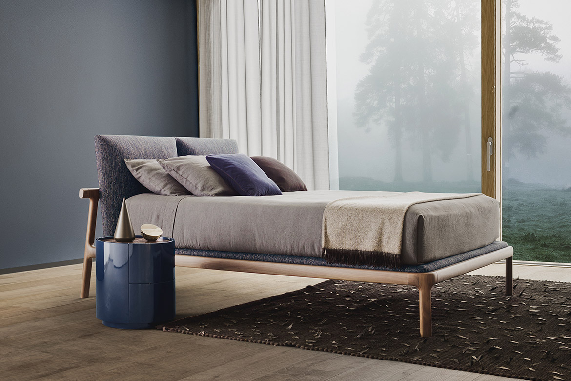 fushimi bed in solid wodd and upholsterd headbord with removable cover and dedalo round drawer unit, teseo black rug handmade by tessoria asolana